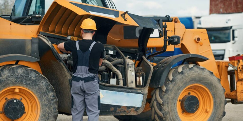 technician performing maintenance on construction equipment to ensure reliable operation and performance.
