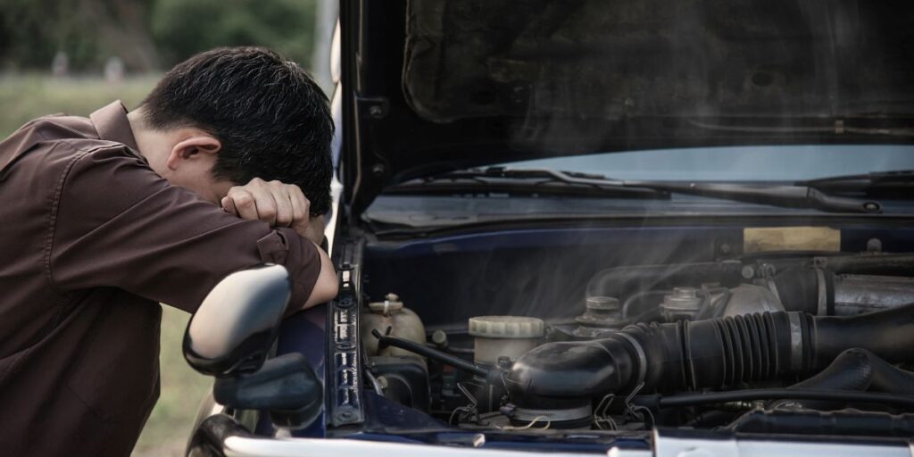 man having problems with his car