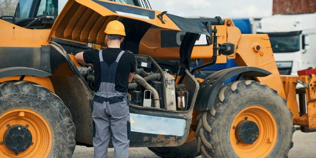 technician performing maintenance on construction equipment to ensure reliable operation and performance.