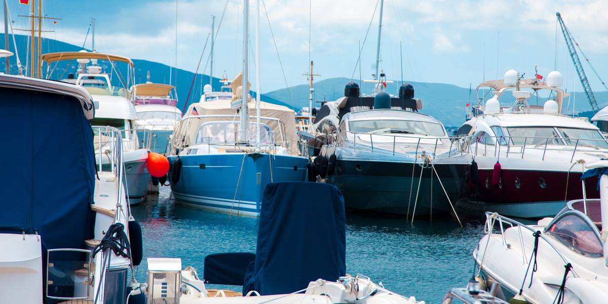 Multiple yachts are moored in a port for maintenance and repair