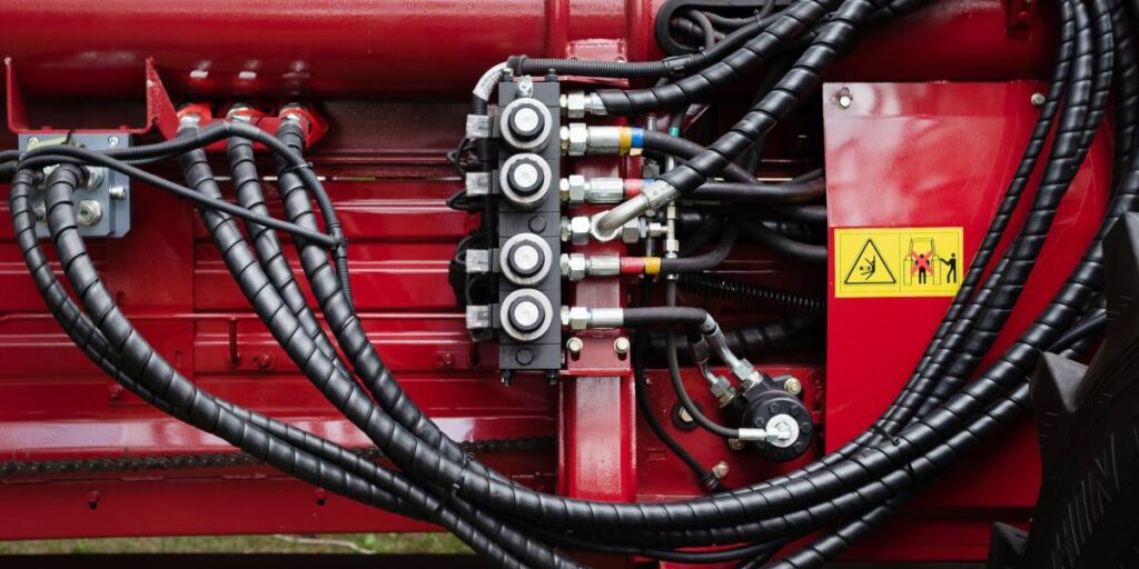 Close-up of hydraulic hoses on a modern machine.