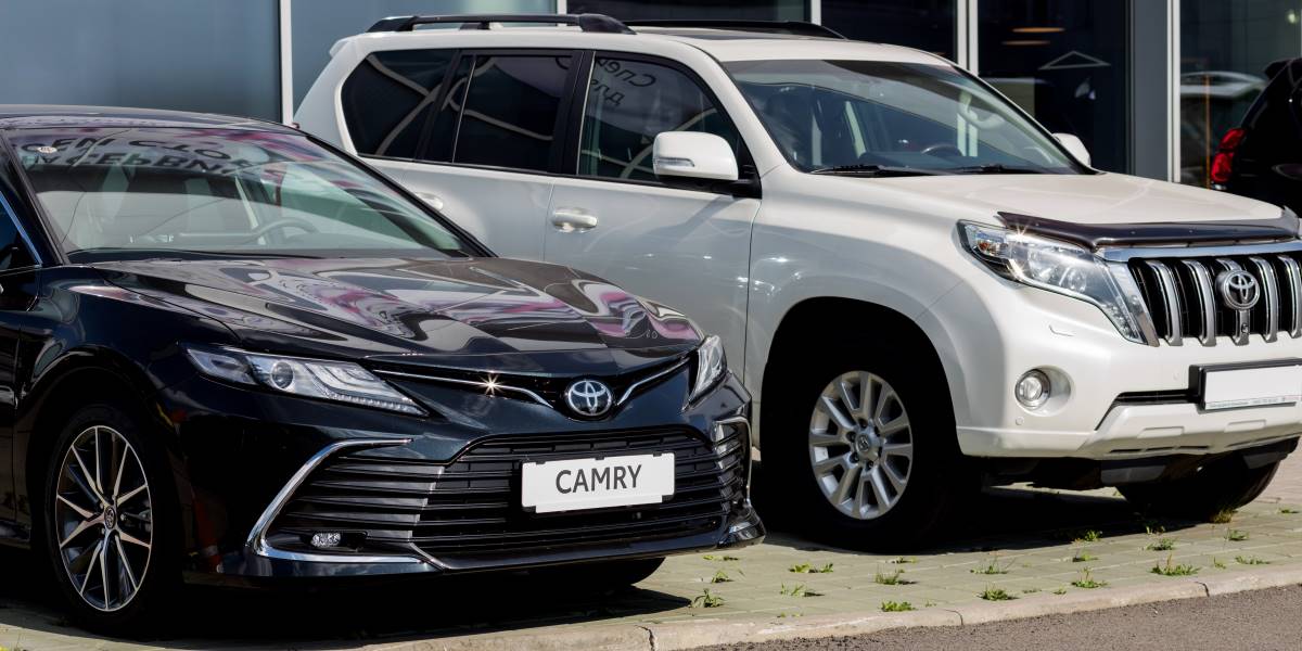 Black Toyota Sedan and White Toyota SUV